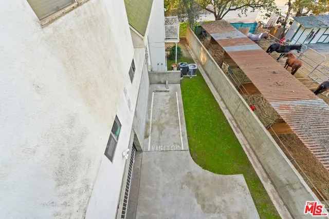 a view of street along with house and trees