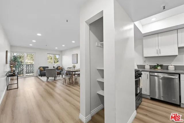 a kitchen with stainless steel appliances granite countertop a stove and a refrigerator