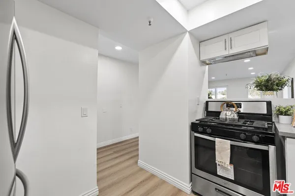 a kitchen with stainless steel appliances a stove and a refrigerator
