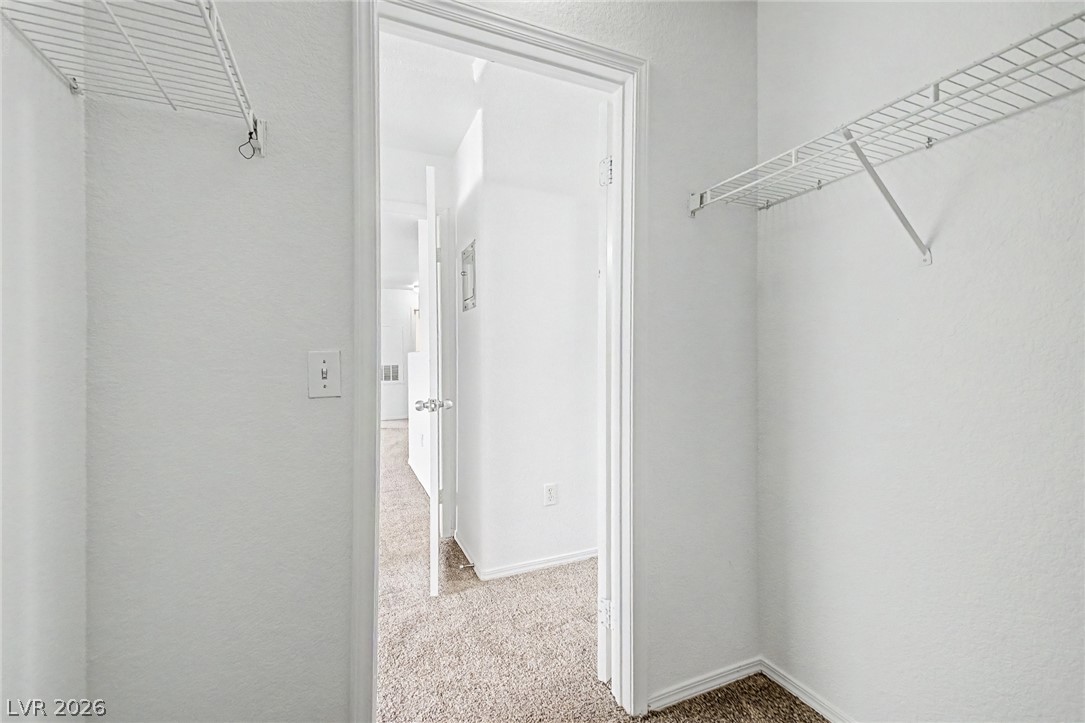 4730 East Craig Road, Unit 2096 Las Vegas, NV 89115 - Photo 16 of 35 Ample storage solutions await within this well-appointed closet, offering practical shelving and easy access.