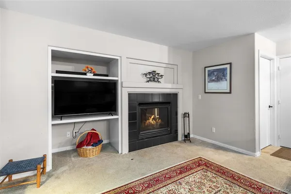 a view of a livingroom with a fireplace and a flat screen tv