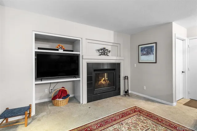 a view of a livingroom with a fireplace and a flat screen tv