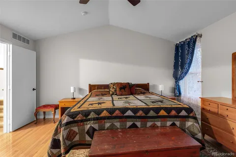 a bed sitting in a bedroom next to a window