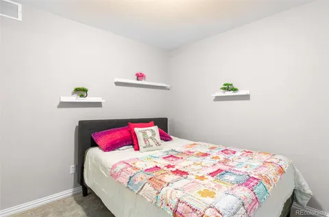 a bedroom with a bed and a dresser