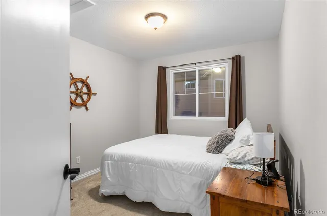 a bedroom with a bed and window