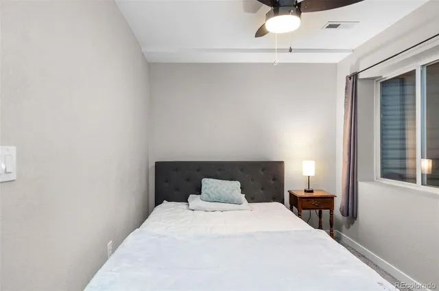 a bedroom with a bed and window