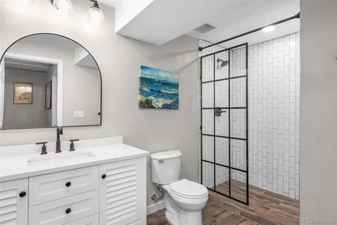 a bathroom with a toilet a sink and mirror