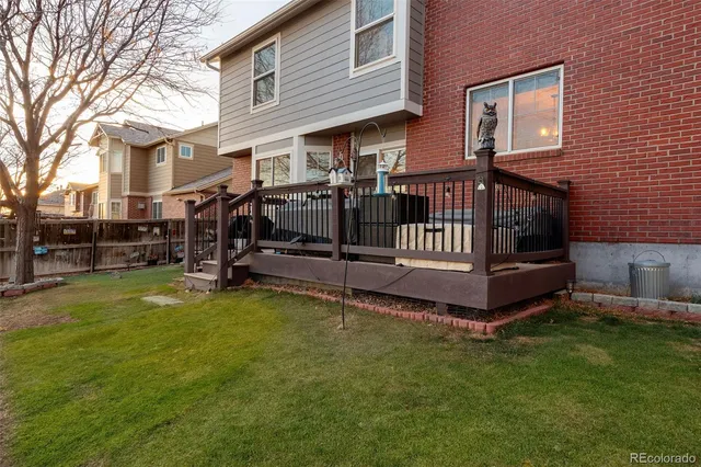 a view of a house with a yard and deck