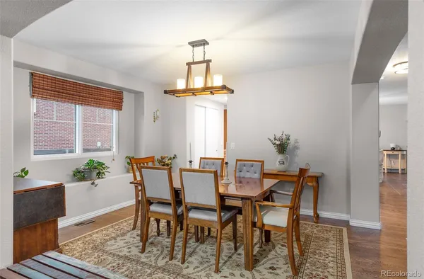a dining room with furniture and window