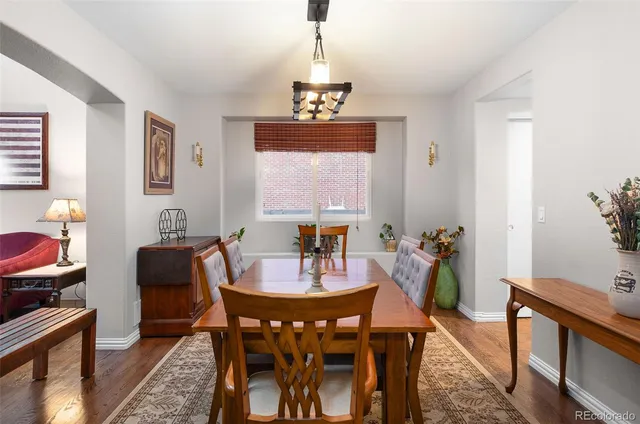 a view of a dining room with furniture window and wooden floor