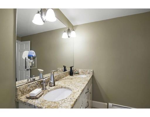 930 Main Street Hingham, MA 02043 - Photo 18 of 30 a bathroom with a granite countertop sink a mirror and vanity