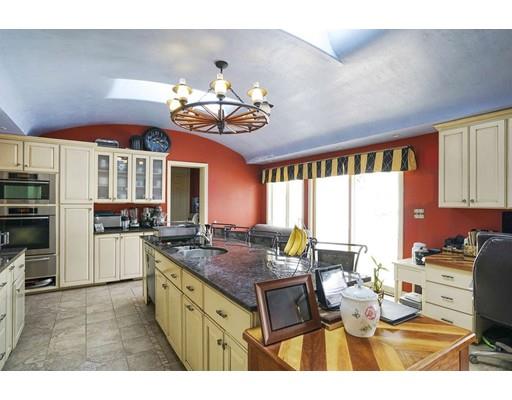 930 Main Street Hingham, MA 02043 - Photo 8 of 30 a kitchen with a stove a sink dishwasher and a dining table with kitchen view