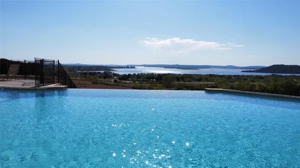a view of a lake with houses in the back