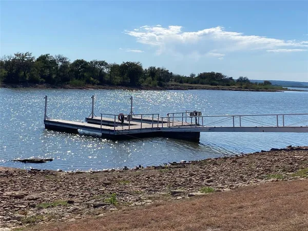a view of a lake with trees in the background