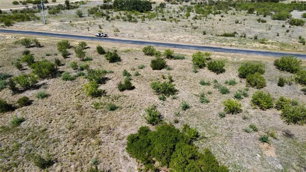 a view of a yard with wooden fence