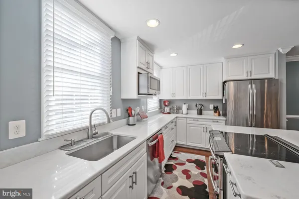 a kitchen with a sink stove and refrigerator