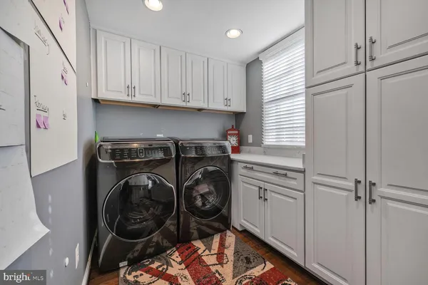 a utility room with sink dryer and washer