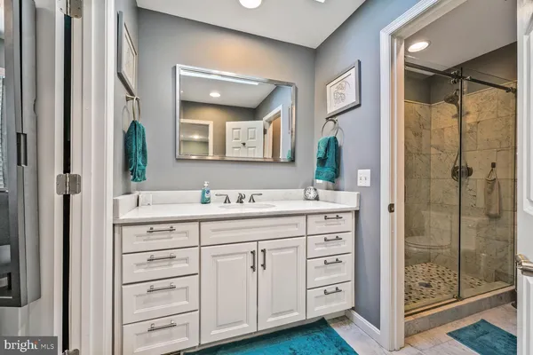 a bathroom with a granite countertop sink mirror and double
