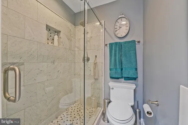 a bathroom with a toilet a sink and shower