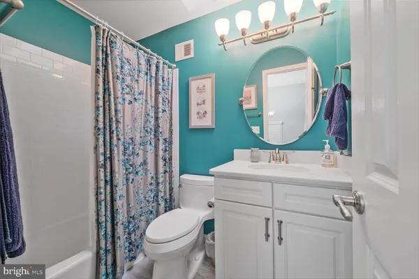 a bathroom with a sink mirror toilet and shower
