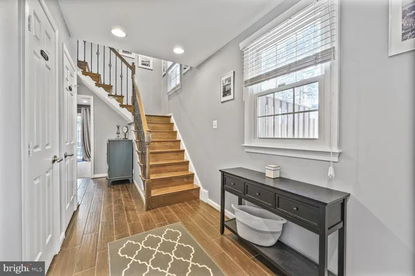 a view of entryway with wooden floor and stairs