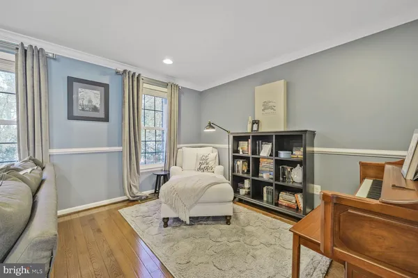 a bedroom with furniture and a book shelf
