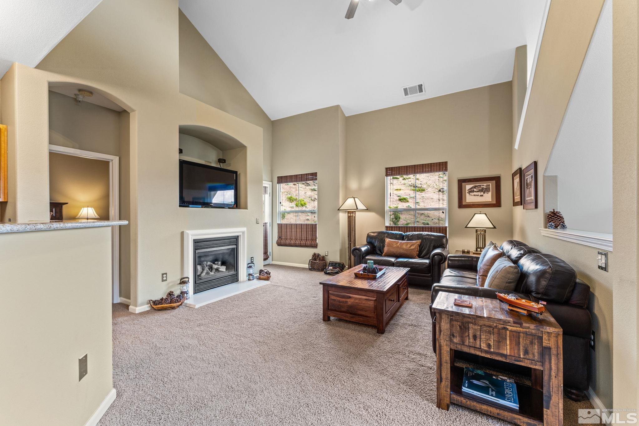 9050 Double R Boulevard, Unit 921 Reno, NV 89521 - Photo 11 of 39 a living room with furniture and a fireplace