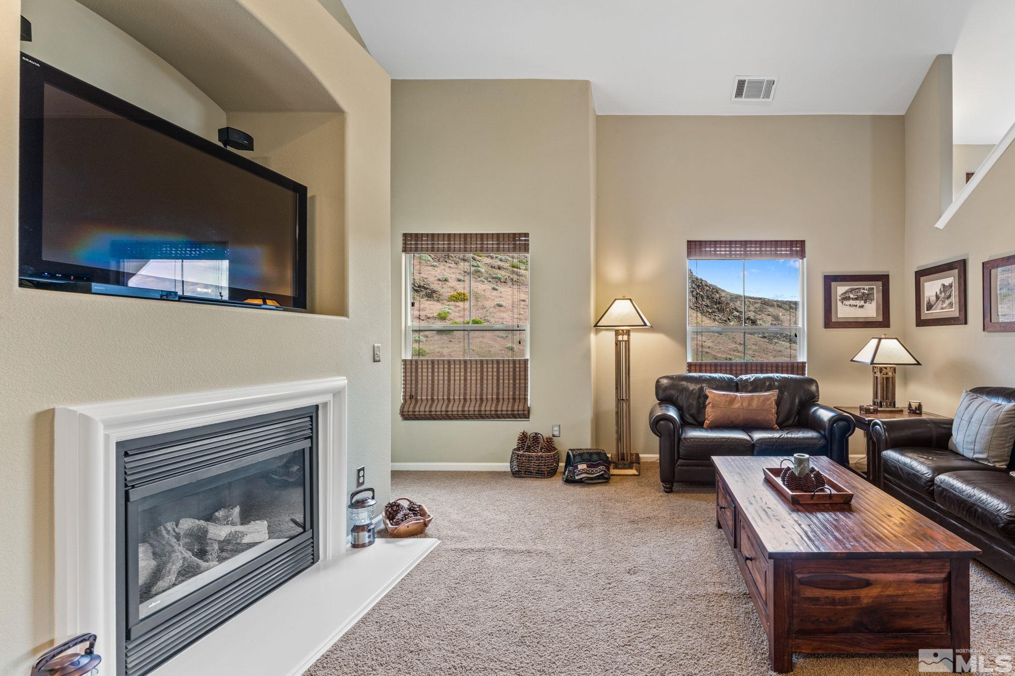 9050 Double R Boulevard, Unit 921 Reno, NV 89521 - Photo 12 of 39 a living room with furniture and a fireplace