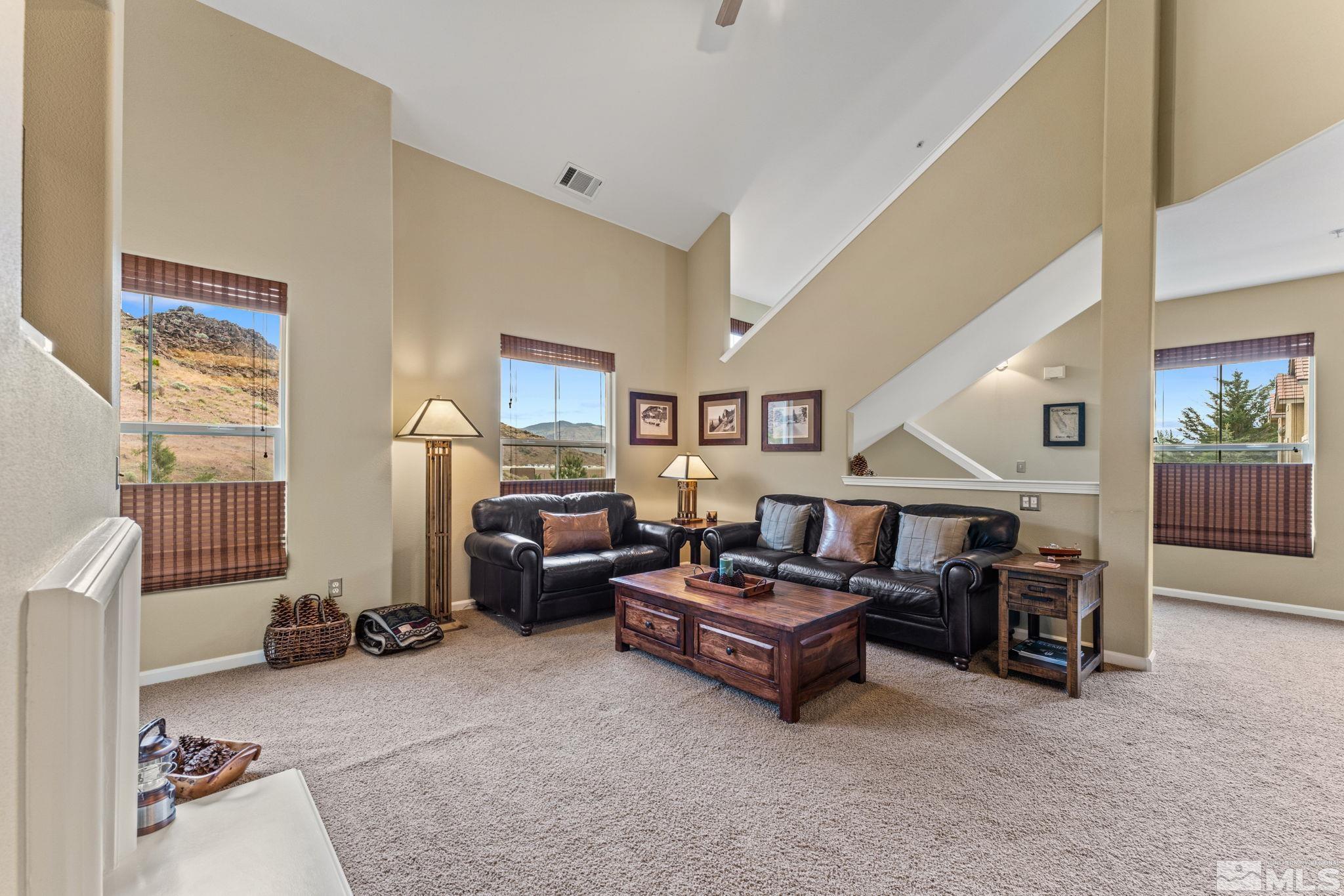 9050 Double R Boulevard, Unit 921 Reno, NV 89521 - Photo 13 of 39 a living room with furniture and a chandelier