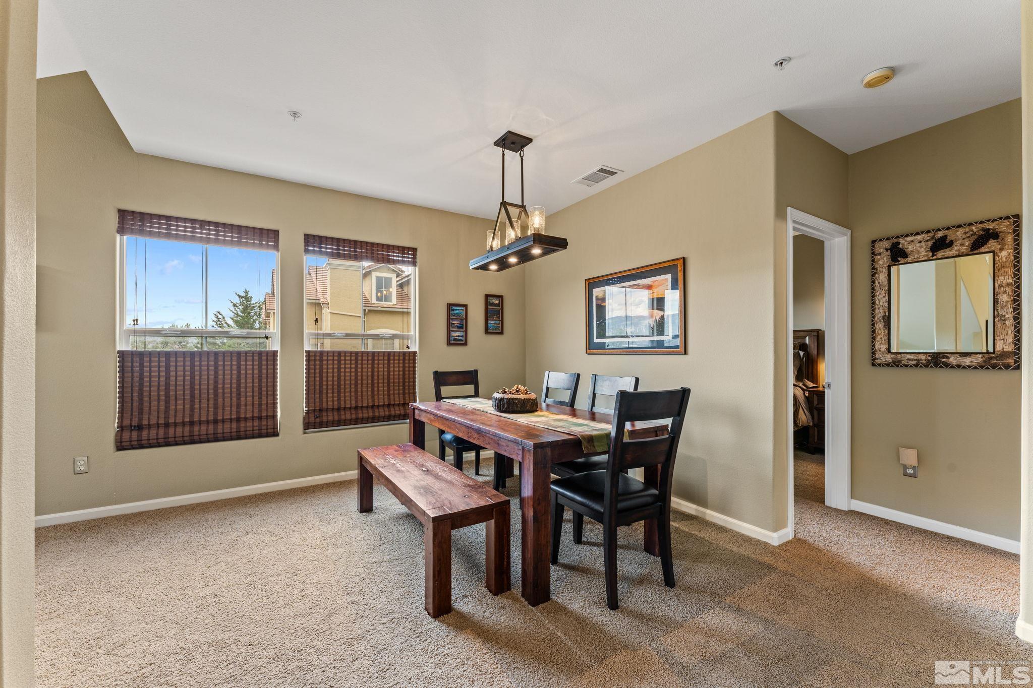9050 Double R Boulevard, Unit 921 Reno, NV 89521 - Photo 16 of 39 a view of a dining room with furniture window and wooden floor
