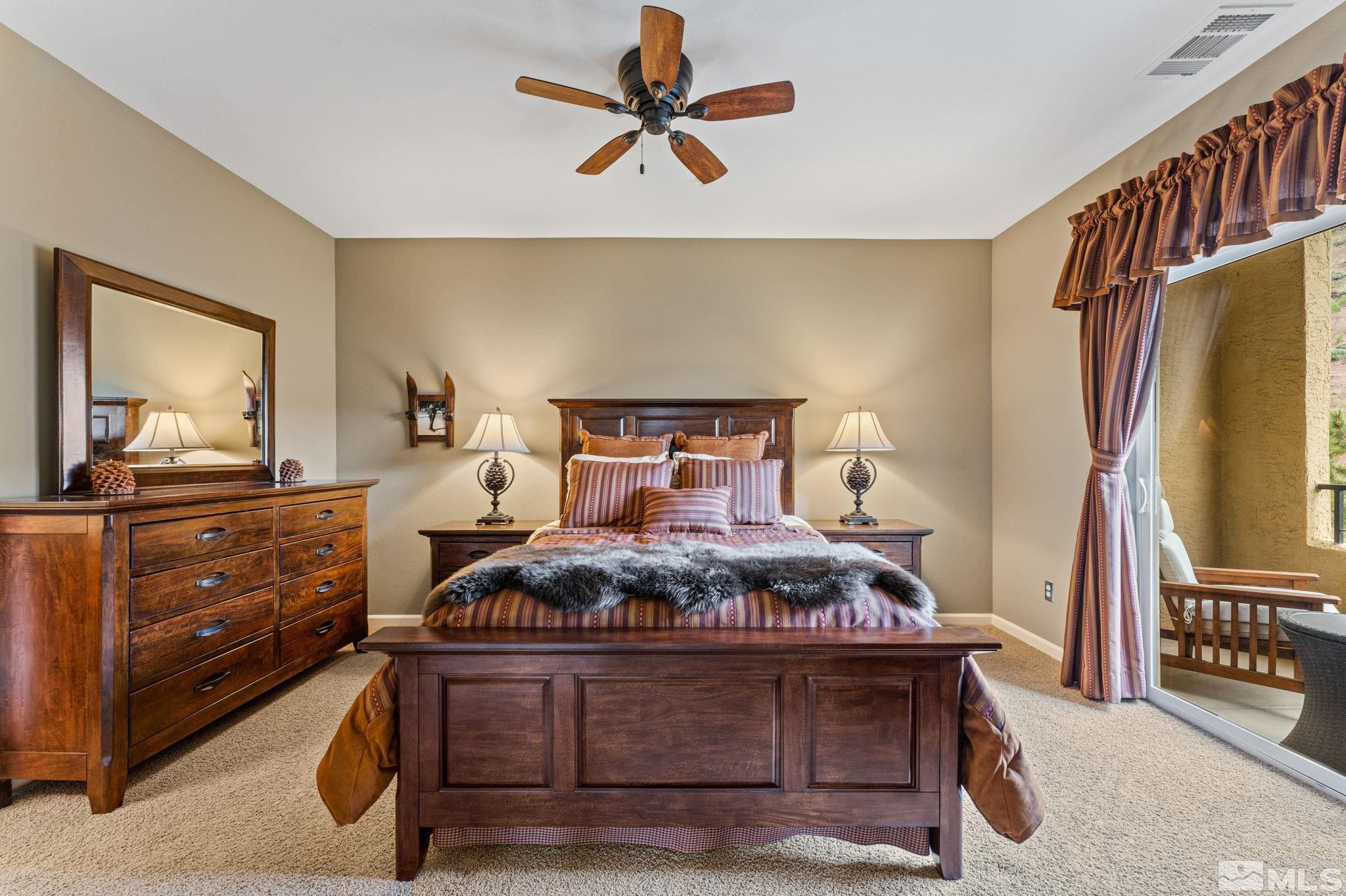 9050 Double R Boulevard, Unit 921 Reno, NV 89521 - Photo 22 of 39 a bedroom with a bed and a flat tv screen on the dresser