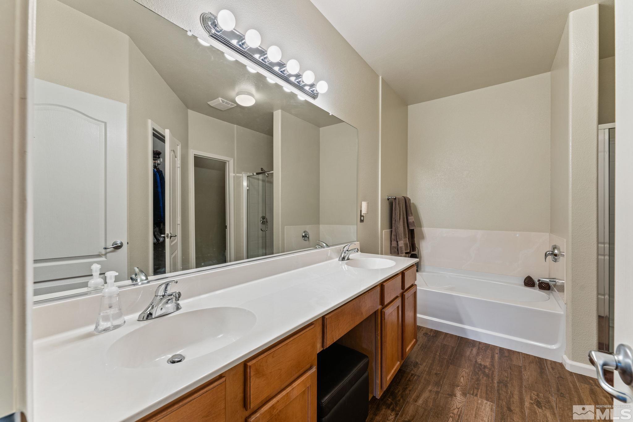 9050 Double R Boulevard, Unit 921 Reno, NV 89521 - Photo 24 of 39 a bathroom with a sink double vanity granite tub and a mirror