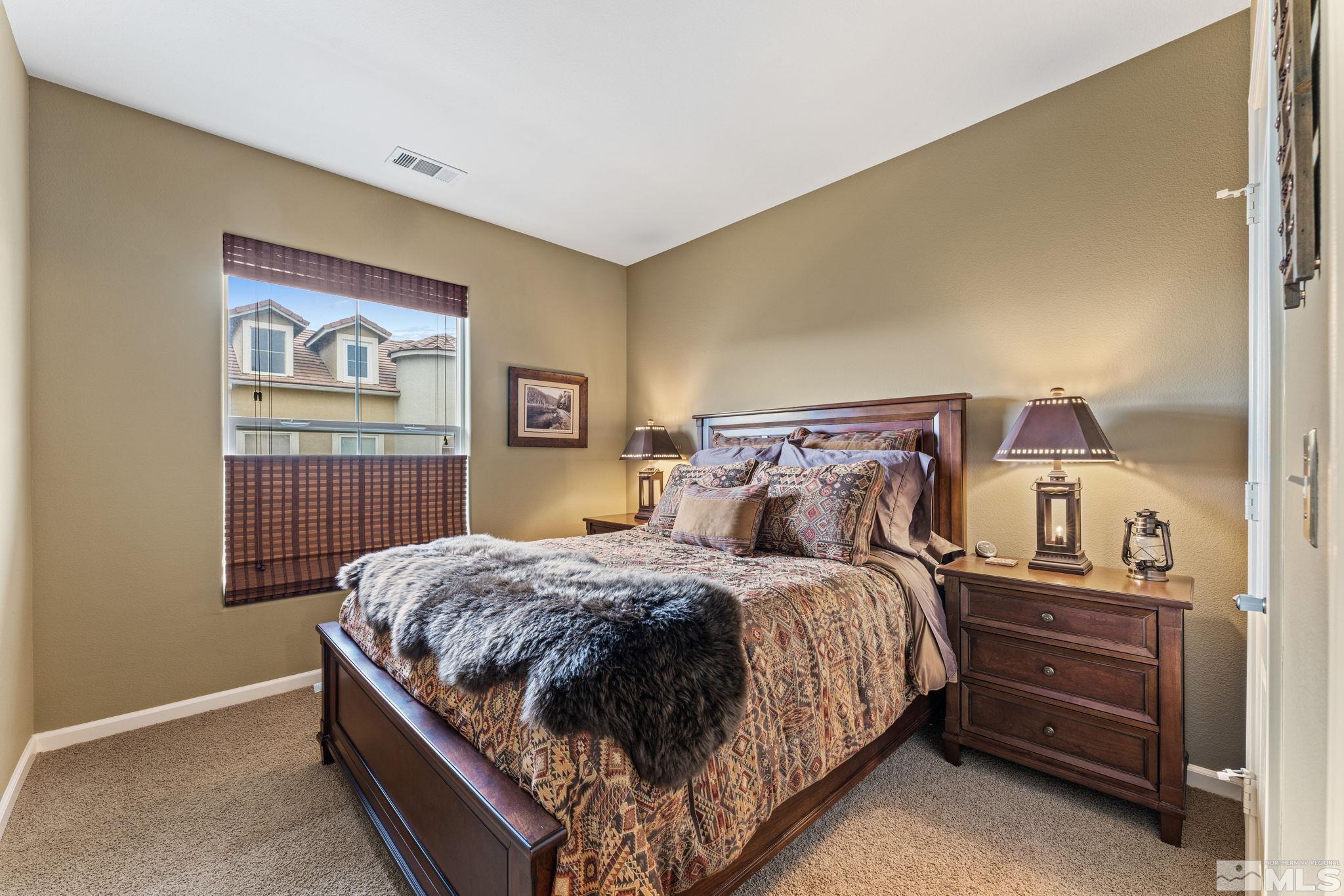 9050 Double R Boulevard, Unit 921 Reno, NV 89521 - Photo 26 of 39 a bedroom with a bed and dresser