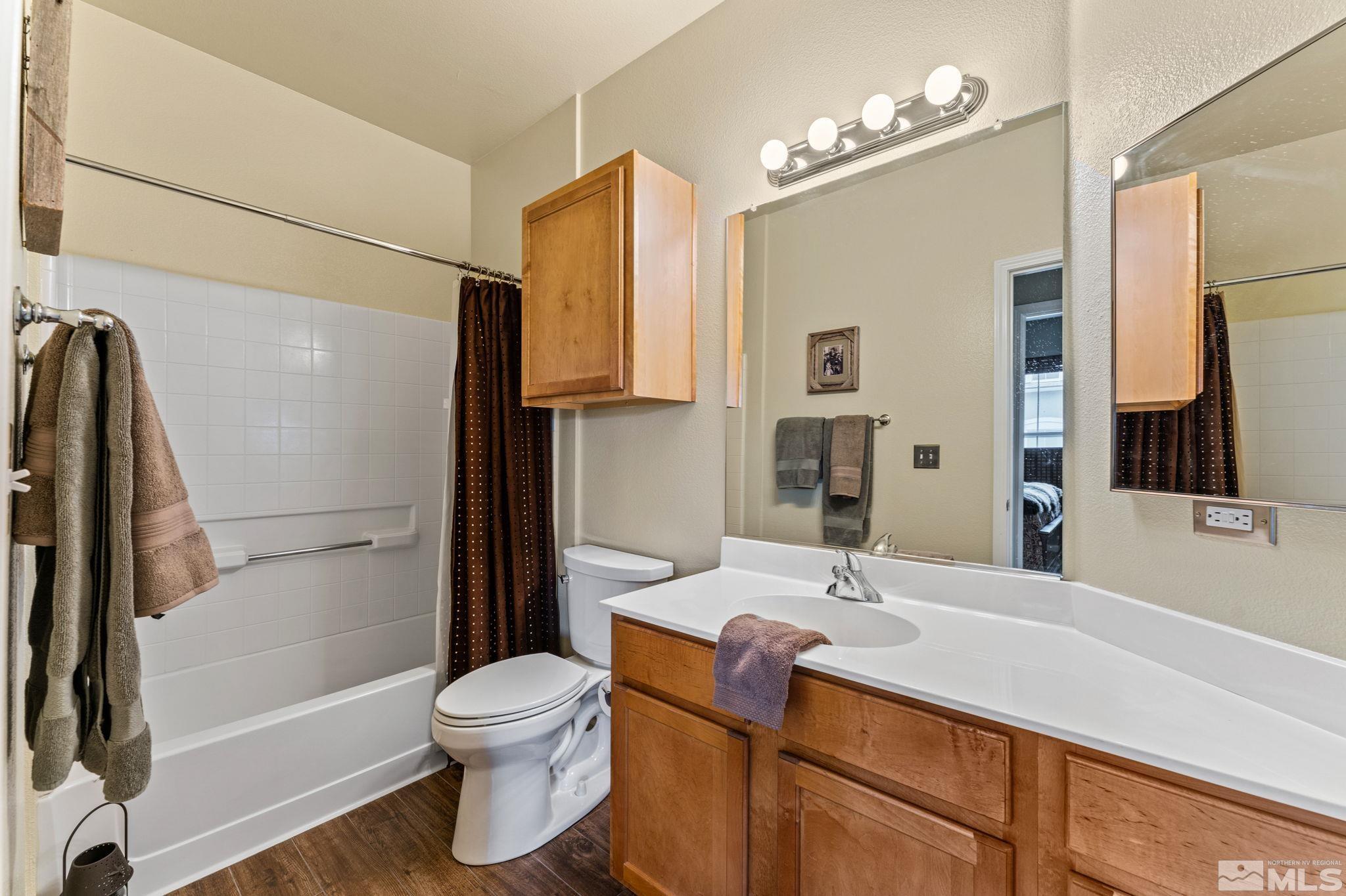 9050 Double R Boulevard, Unit 921 Reno, NV 89521 - Photo 28 of 39 a bathroom with a sink a toilet and shower