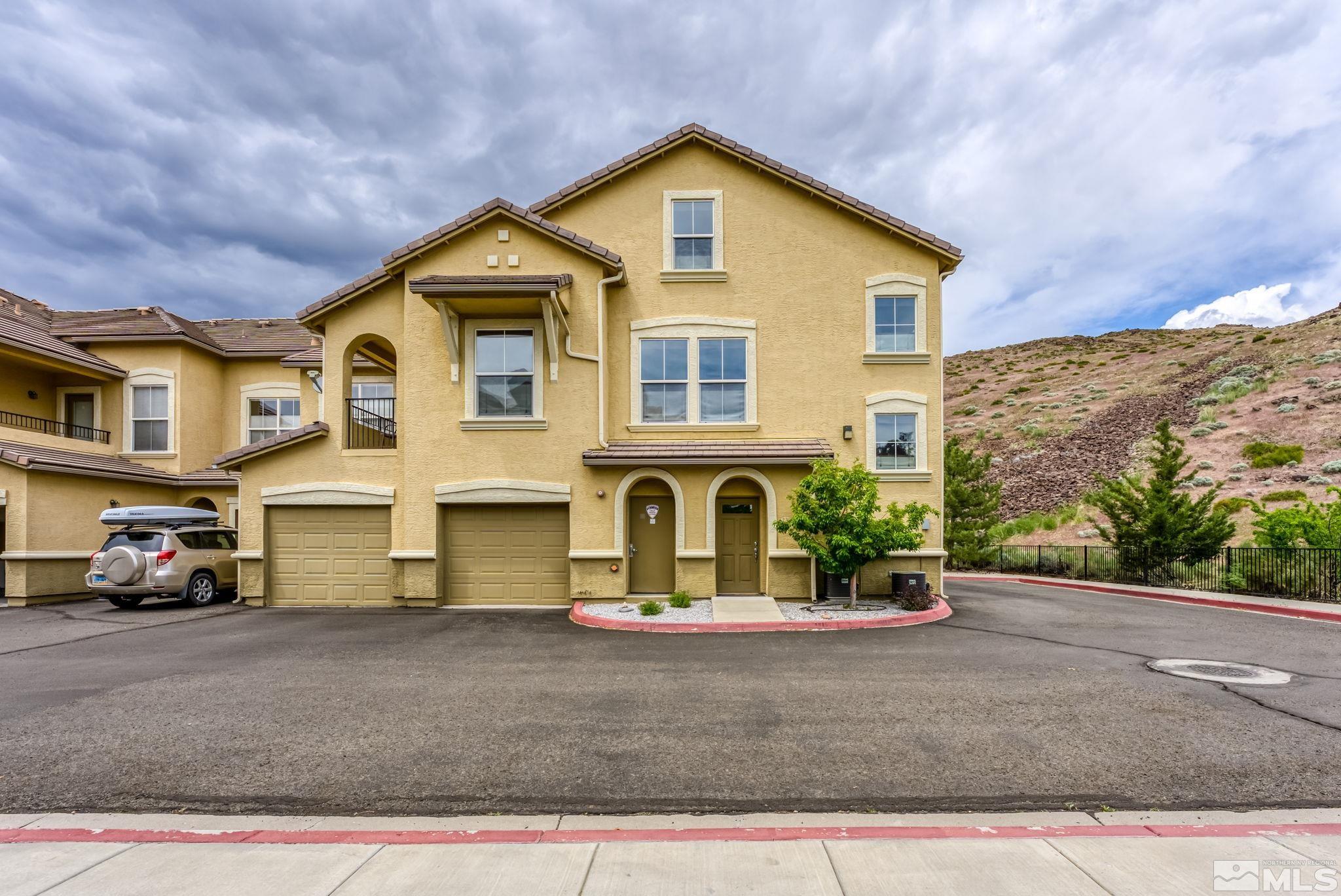 9050 Double R Boulevard, Unit 921 Reno, NV 89521 - Photo 3 of 39 a front view of a house with garage