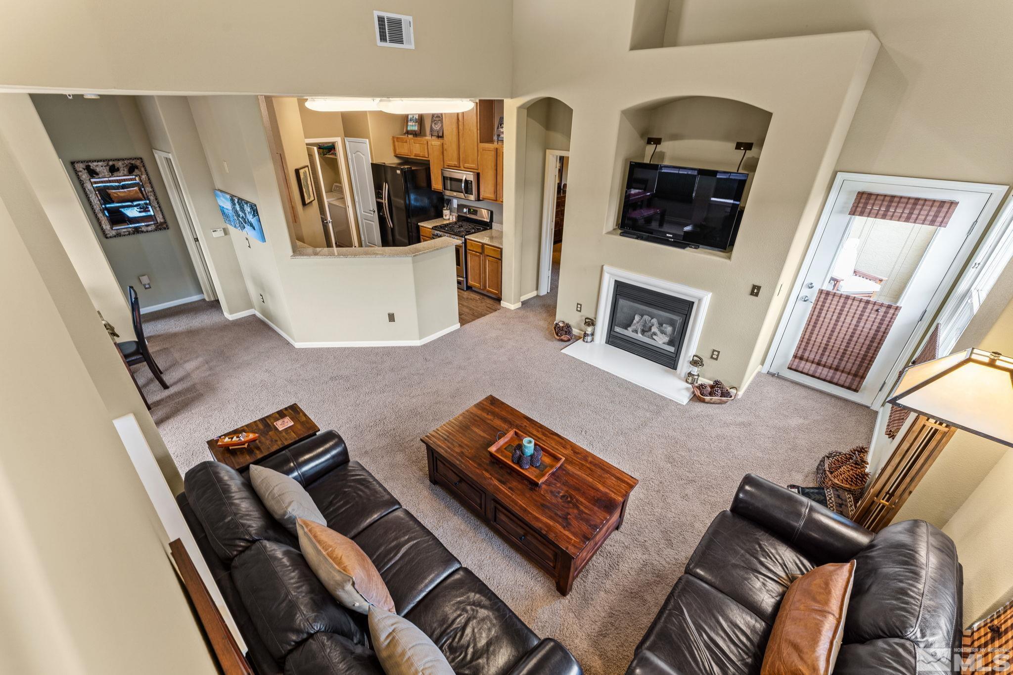 9050 Double R Boulevard, Unit 921 Reno, NV 89521 - Photo 31 of 39 a living room with furniture and a flat screen tv
