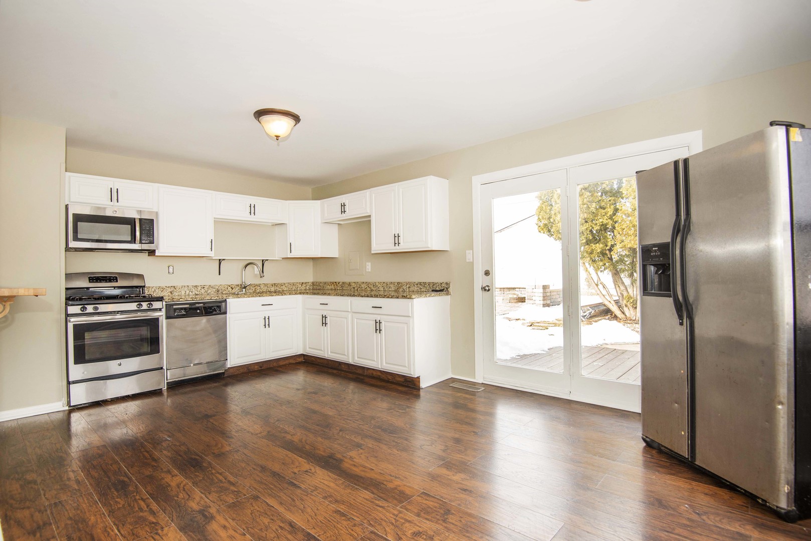 412 Haller Avenue Romeoville, IL 60446 - Photo 7 of 19 a large kitchen with a white stove top oven and refrigerator