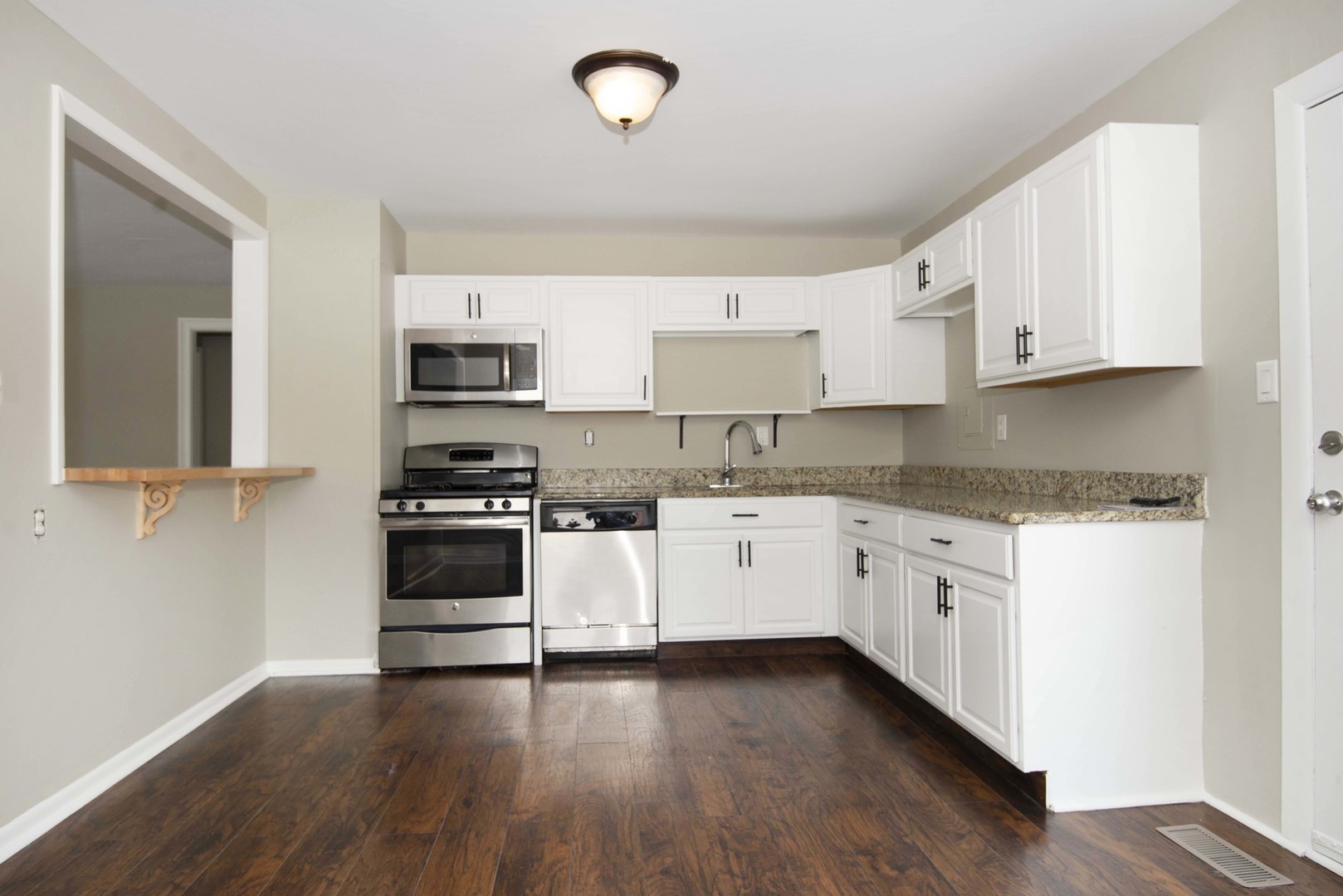 412 Haller Avenue Romeoville, IL 60446 - Photo 8 of 19 a kitchen with granite countertop white cabinets and white appliances