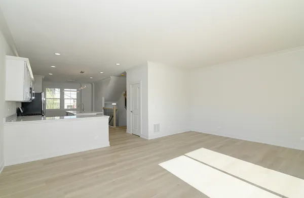 a view of kitchen and hall with wooden floor