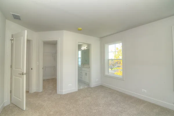 an empty room with windows and closet