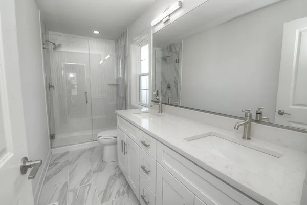 a bathroom with a double vanity sink mirror double and shower