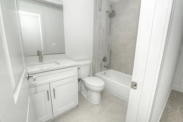 a bathroom with a sink toilet vanity and shower