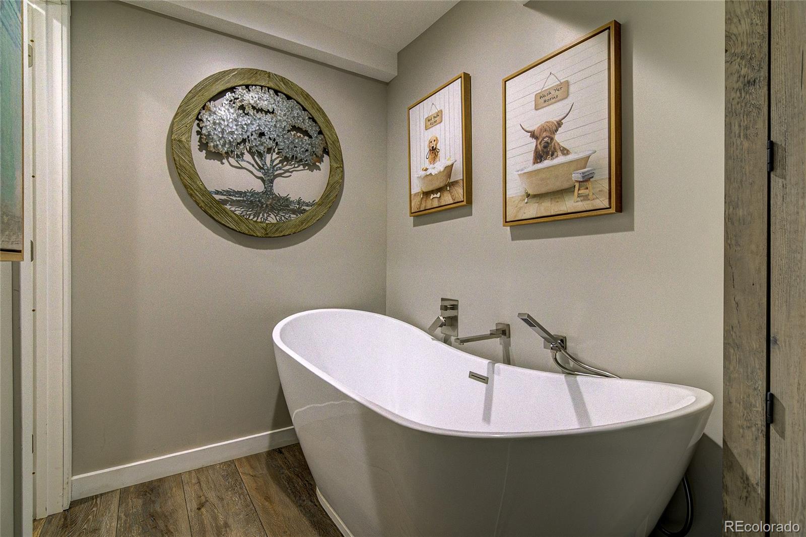4531 East Best Road Larkspur, CO 80118 - Photo 18 of 49 a white bath tub sitting in a bathroom
