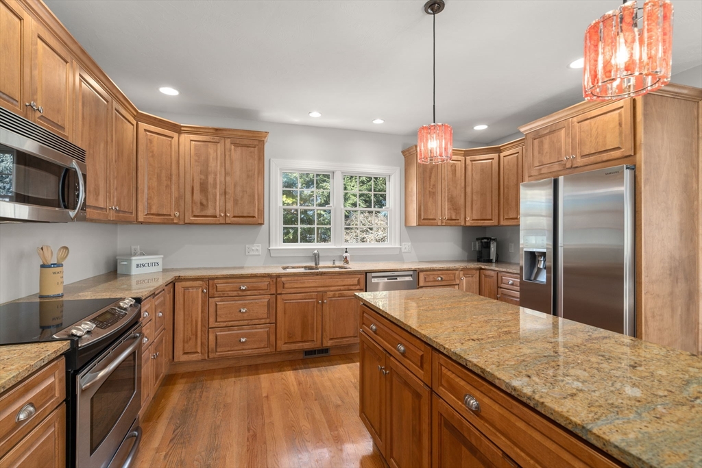 36 Sherman's Bridge Road Wayland, MA 01778 - Photo 9 of 39 a kitchen with granite countertop a sink stainless steel appliances and cabinets