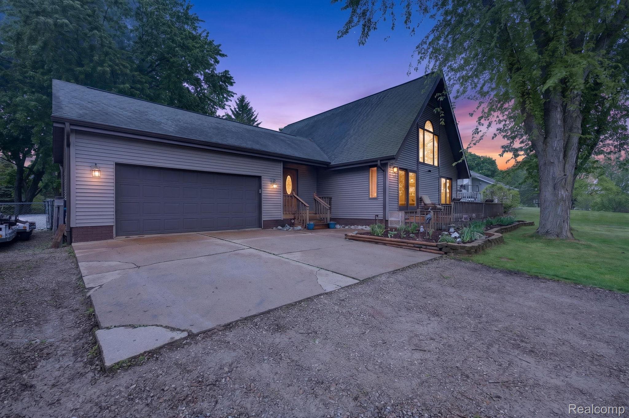 1280 Petts Road Fenton, MI 48430 - Photo 2 of 62 View of front facade with driveway, a garage, a yard, and a shingled roof