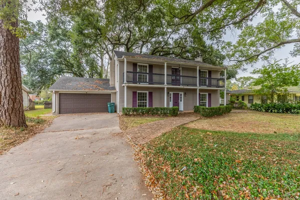 a view of a hallway with wooden floor and entryway