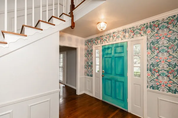 a view of an entryway with wooden floor and door