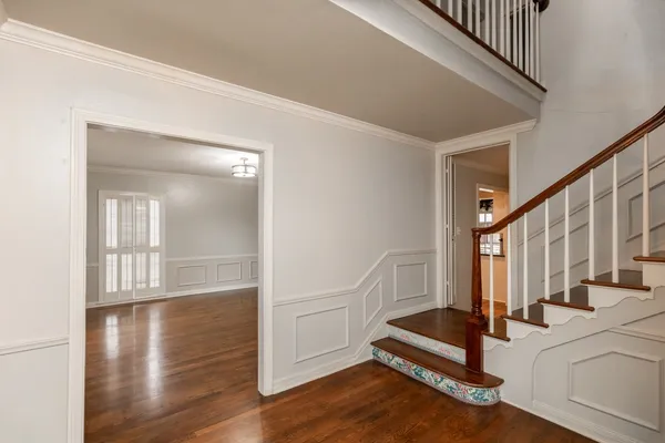 a view of entryway with wooden floor and stairs