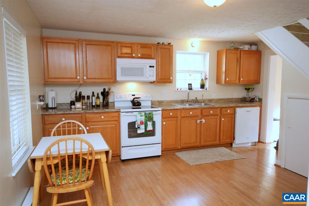 1264 Ridgeview Road Reva, VA 22735 - Photo 7 of 43 a kitchen with granite countertop a stove a sink and a wooden cabinets