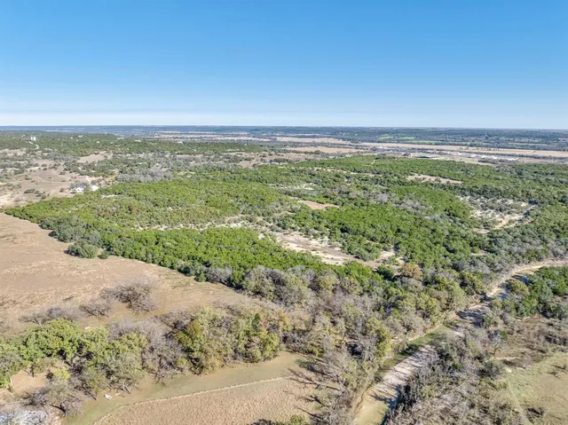 a view of a field with an ocean